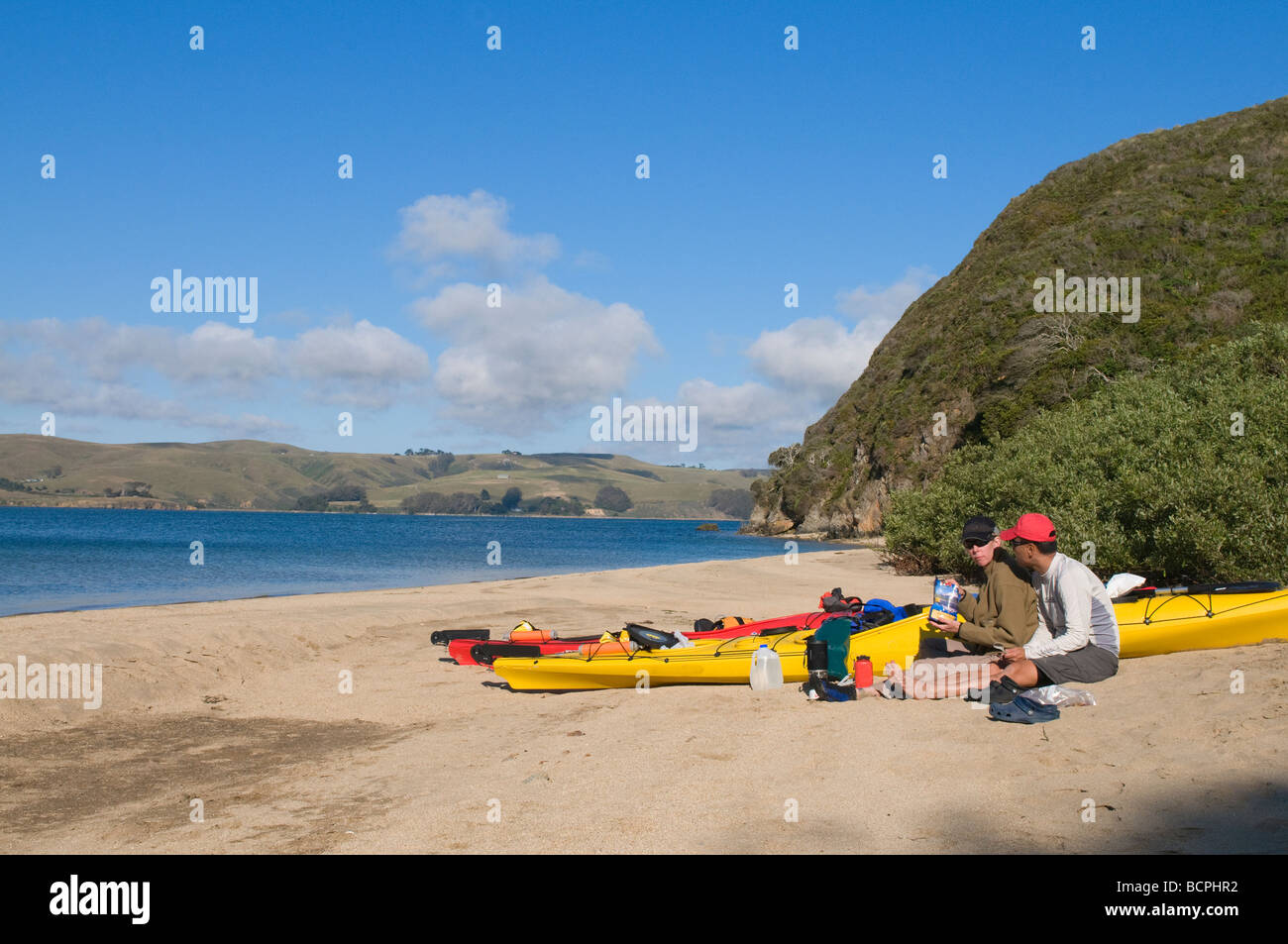 couple on beach with kayaks at tomales bay Stock Photo Alamy