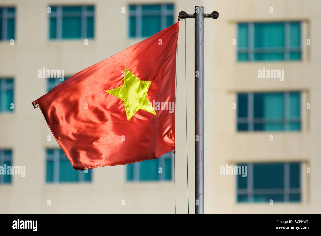 Vietnamese flag flying in Ho Chi Minh City, Vietnam Stock Photo