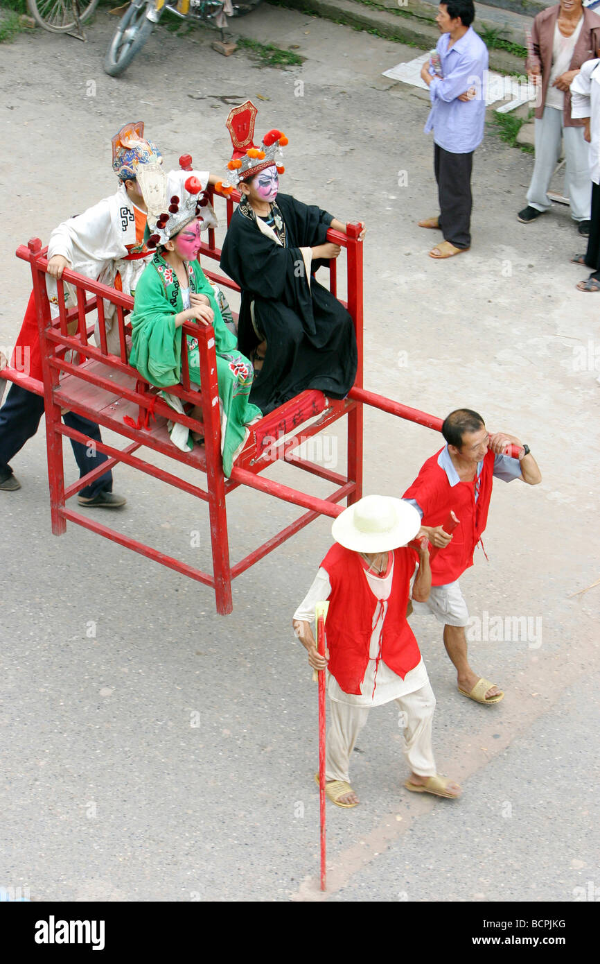 Chinese Boys In Heavy Makeup And Costume Being Carried In A