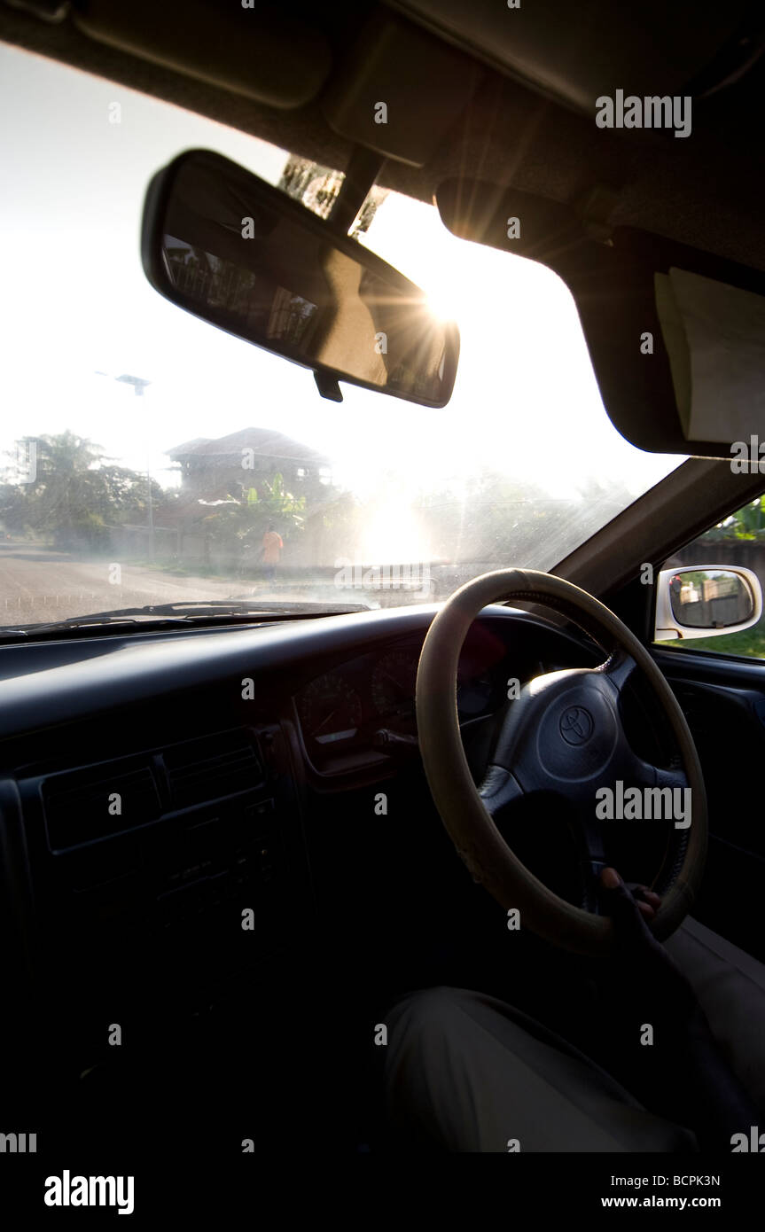 Rear view mirror on sunny day in Ugandan taxi Stock Photo