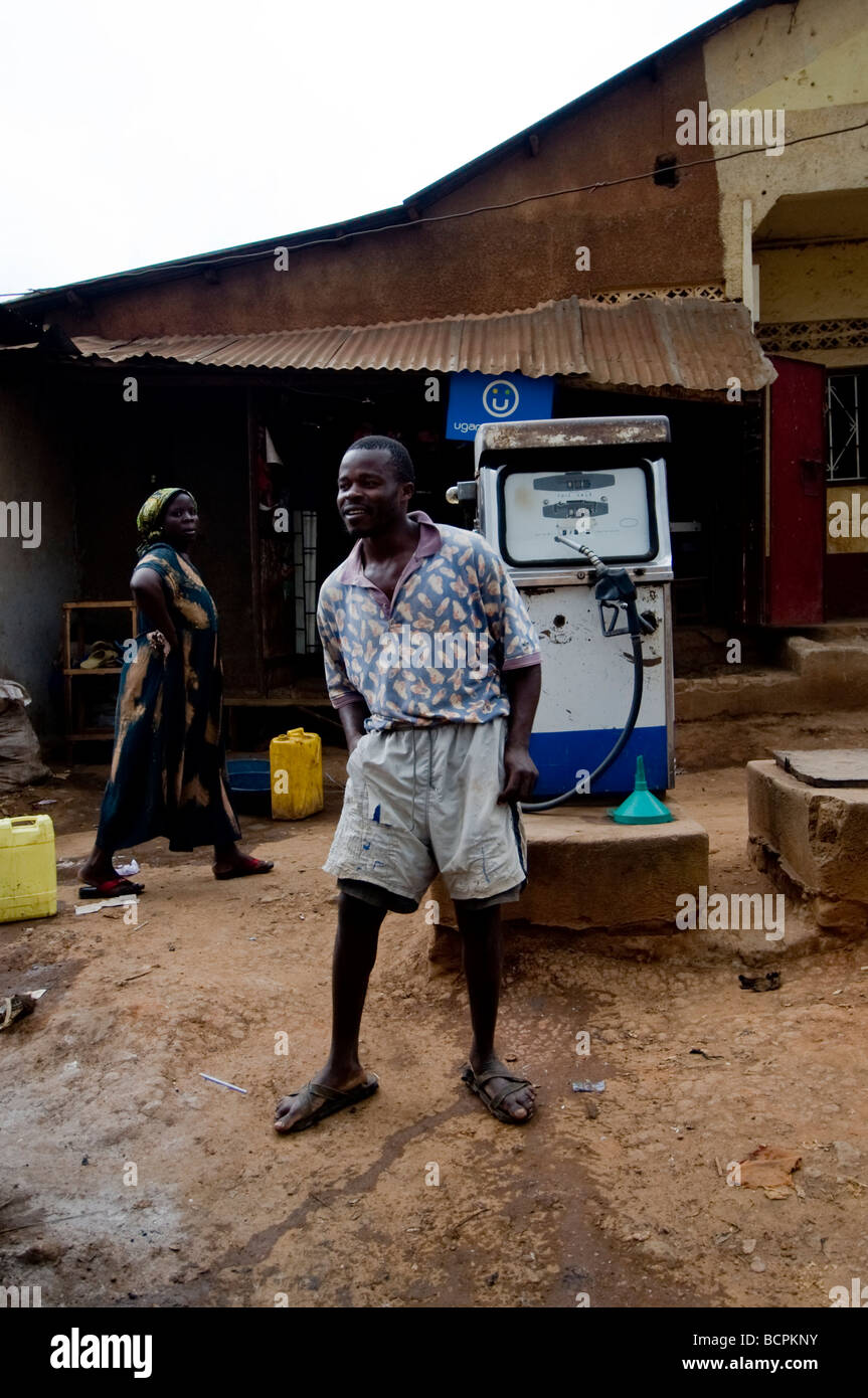 African man dancing by petrol pump on street of Ugandan slum Stock Photo