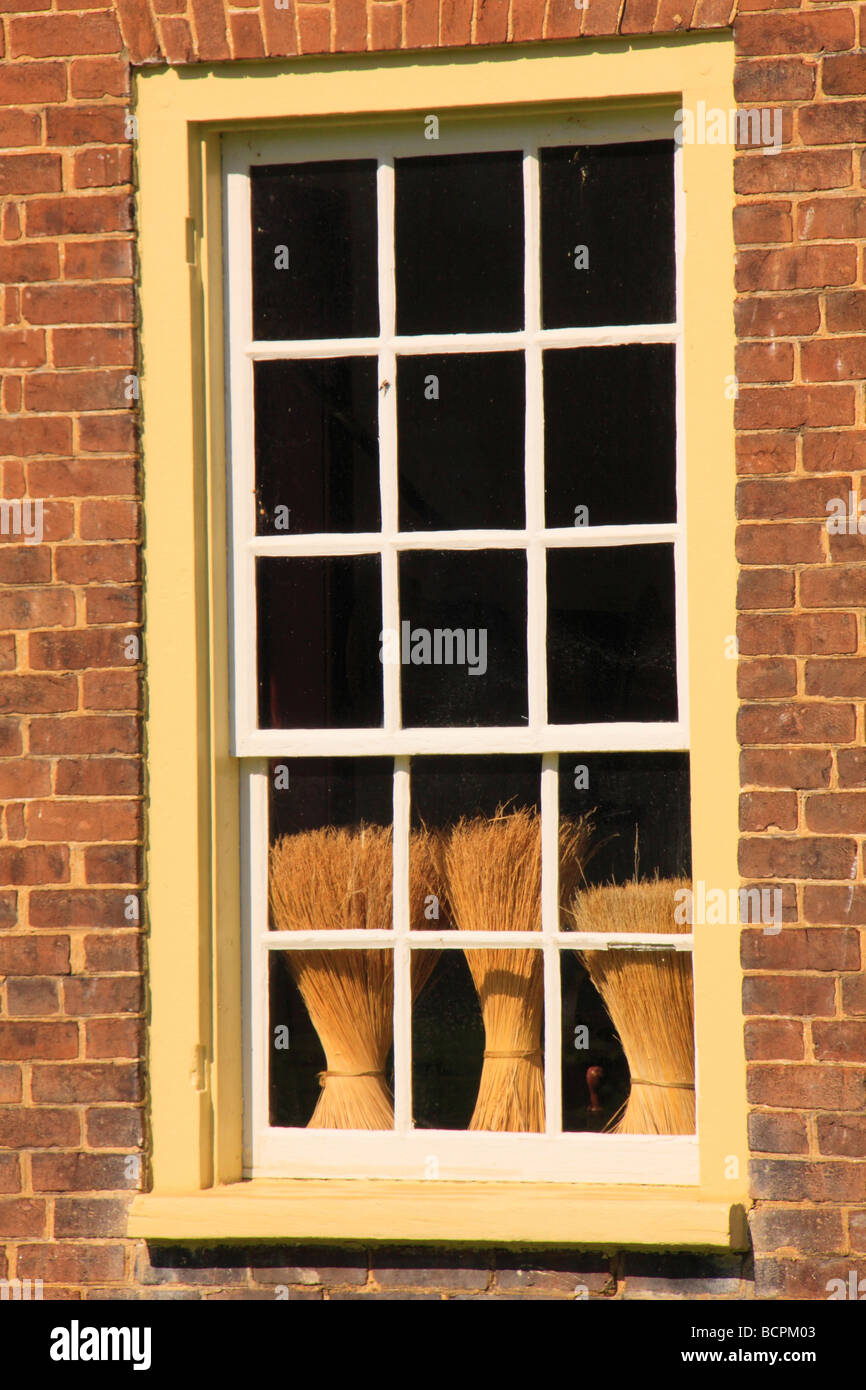 Brooms seen through window of East Family Brethren s Shop at Shaker Village of Pleasant Hill Harrodsburg Kentucky Stock Photo