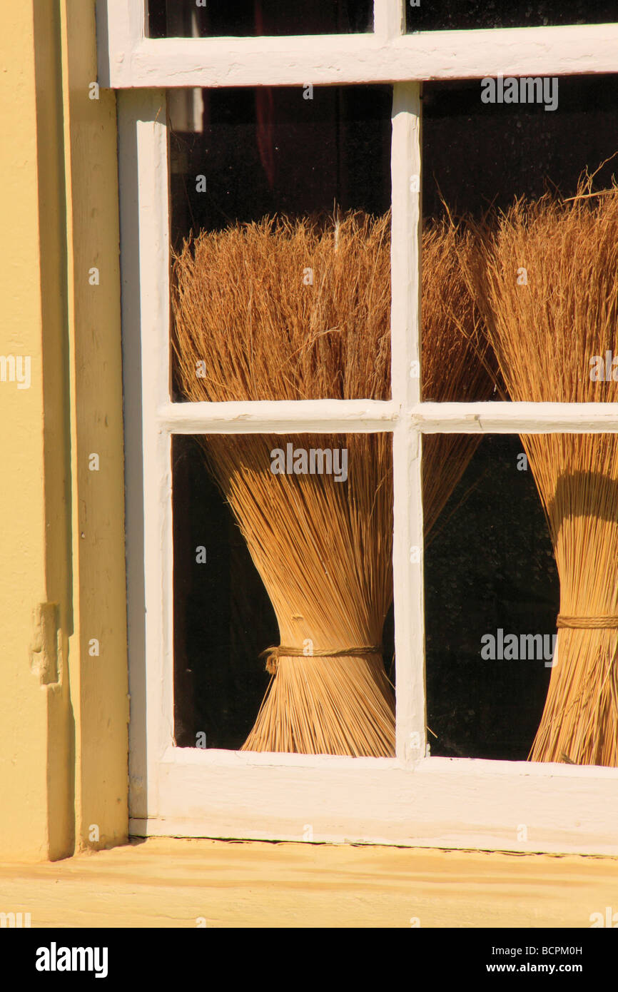 Brooms seen through window of East Family Brethren s Shop at Shaker Village of Pleasant Hill Harrodsburg Kentucky Stock Photo