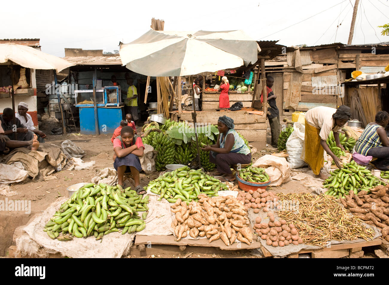 Vegetables for sale on floor of roadside market in Kamwockya Kampala Uganda Stock Photo