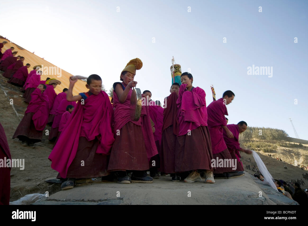 Boy lamas gathering for unveiling of Buddha Tangka at Drepung Monastery during Shoton (Yogurt) Festival, Lhasa, Tibet, China Stock Photo