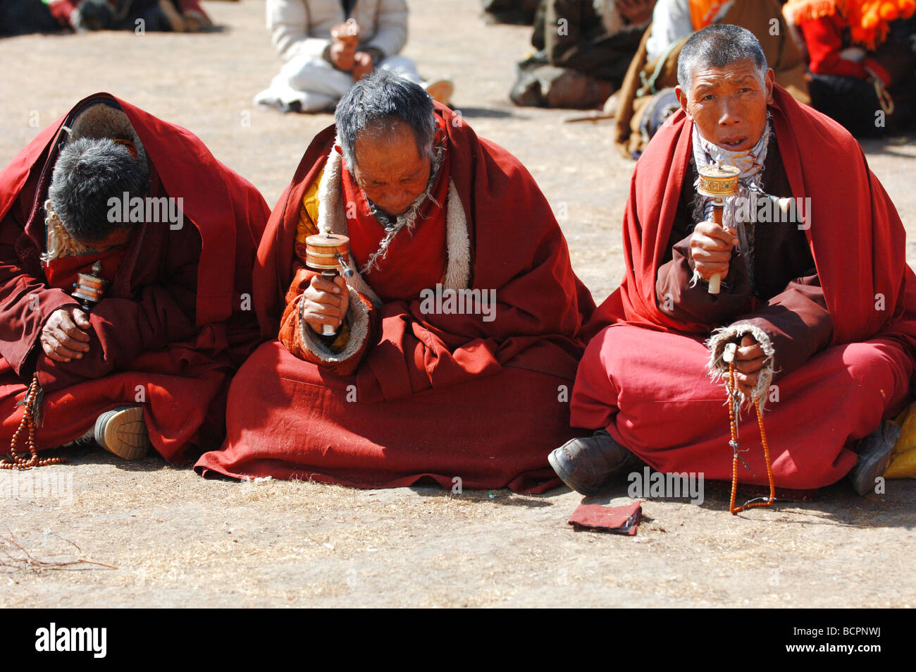 Three monks praying during, religious ceremony in a local Tibetan