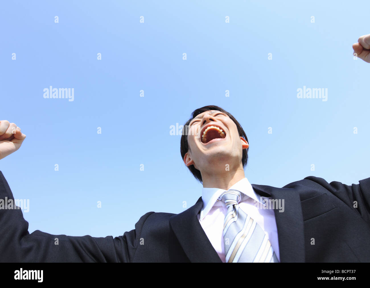 Businessman with his fist in the air Stock Photo - Alamy