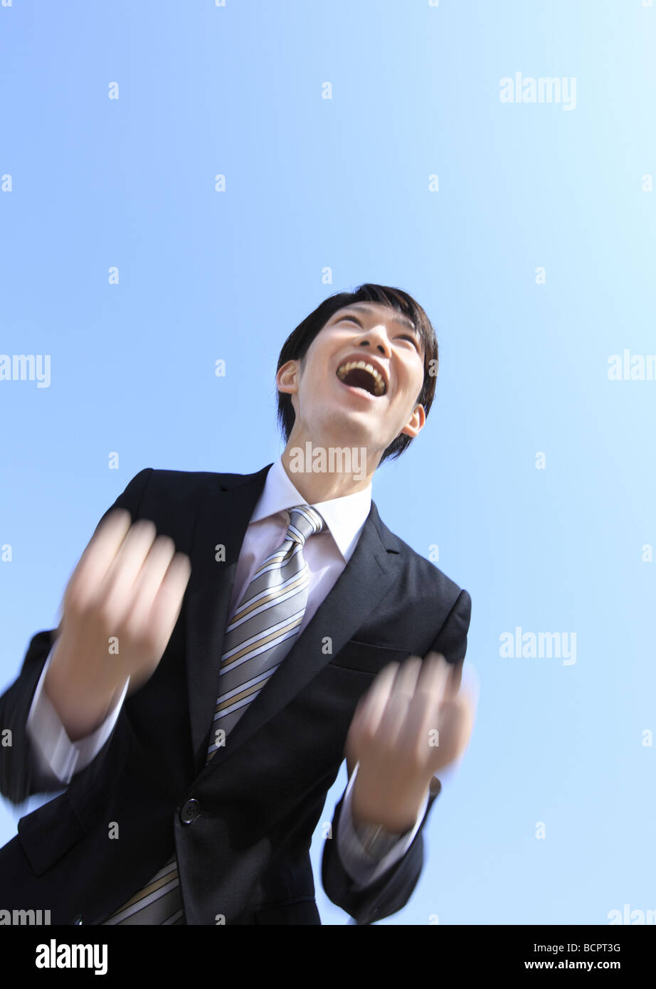 Businessman with his fist in the air Stock Photo - Alamy