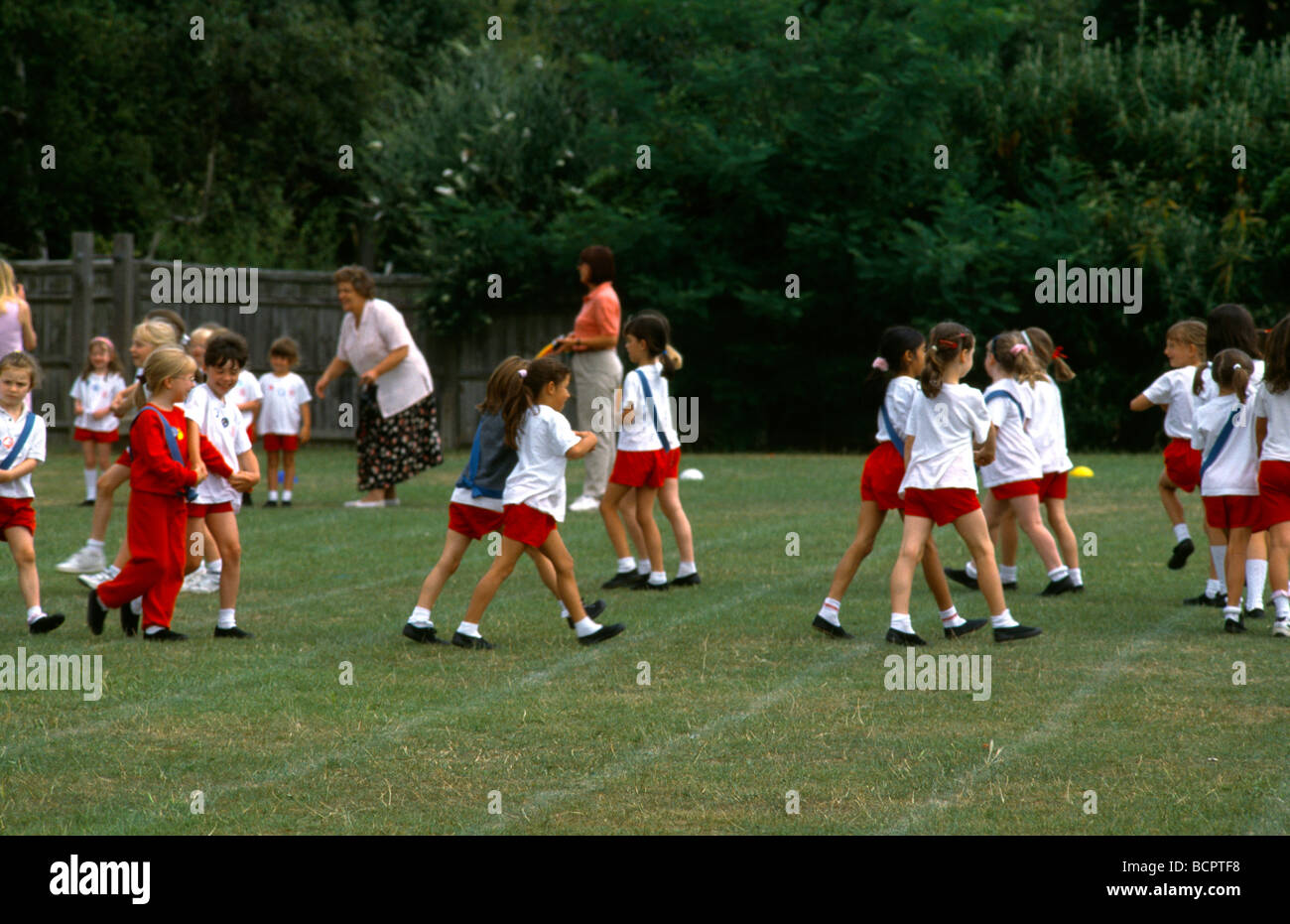 Primary School Children Doing Country Dancing On Sports Day Stock Photo