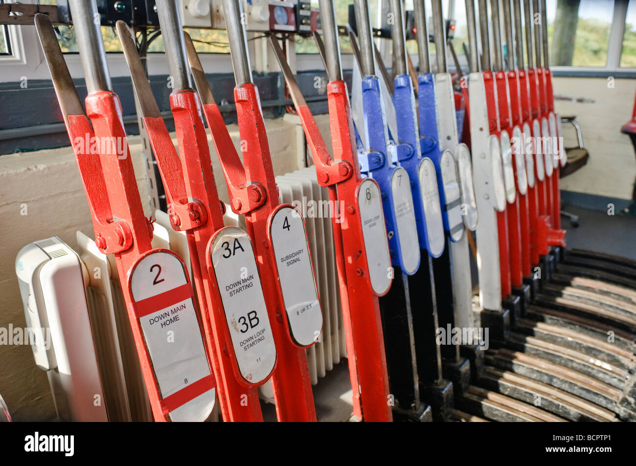 Levers on a lever frame in a manually operated signal box to operate points and signals Stock Photo