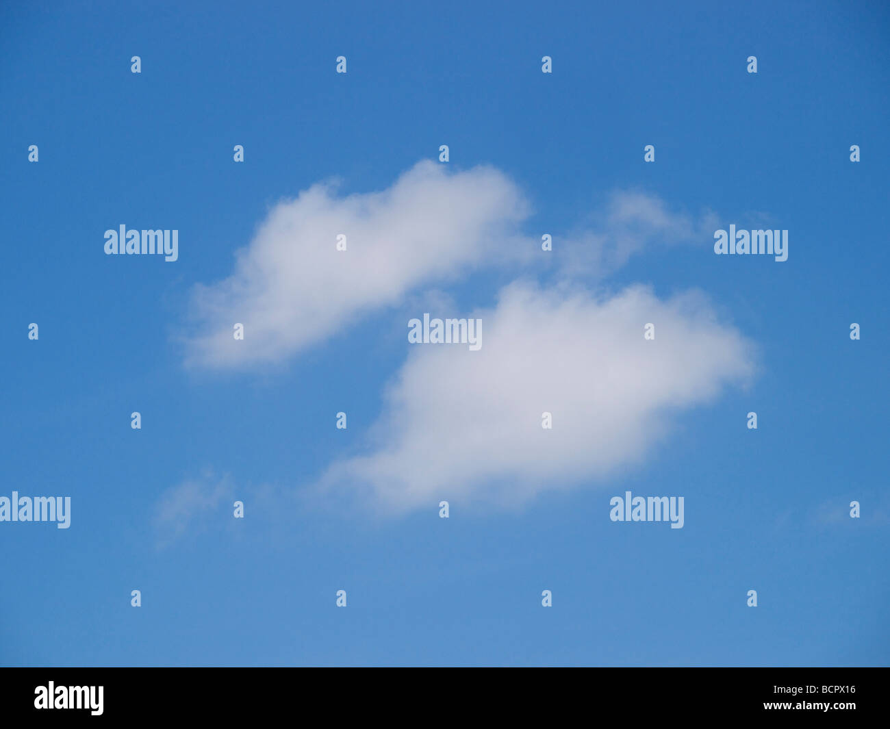 Blue sky with two little white clouds Stock Photo