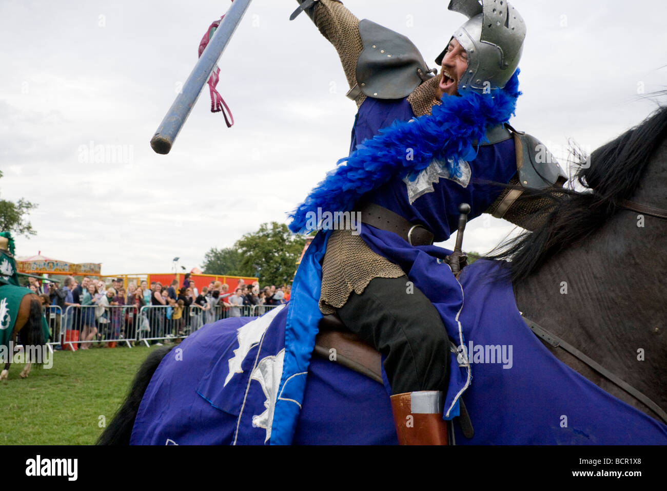 Medieval knight galloping on horseback holding the standard aloft in ...