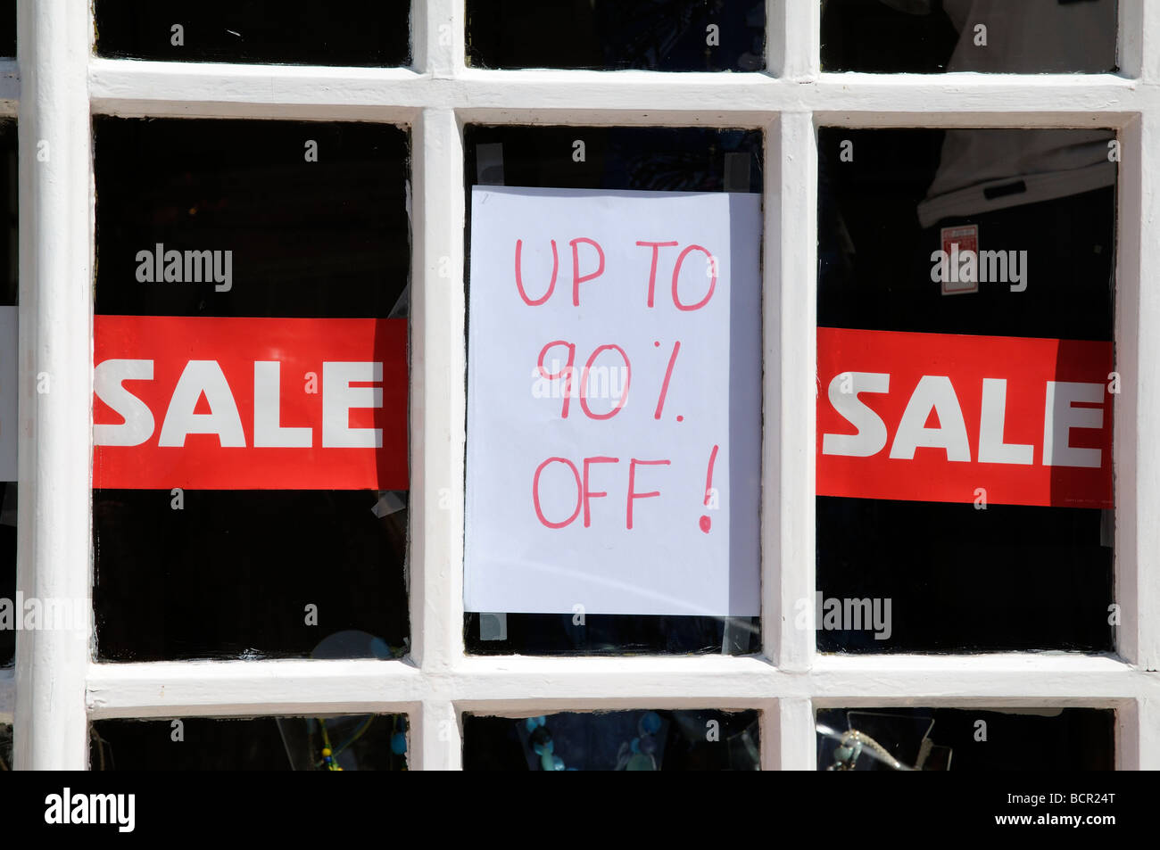 Sale sign upto 90 percent reductions in a shop window during the British recession Stock Photo