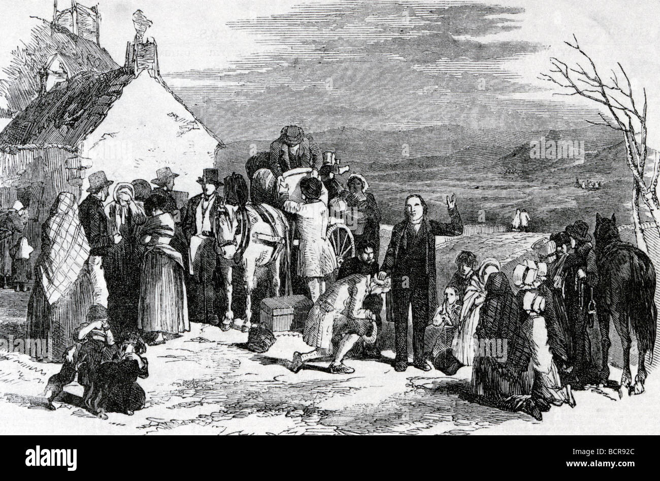 IRELAND EMIGRATION - A priest gives his blessing as a poor family prepare to leave their home and emigrate to America in 1845 Stock Photo