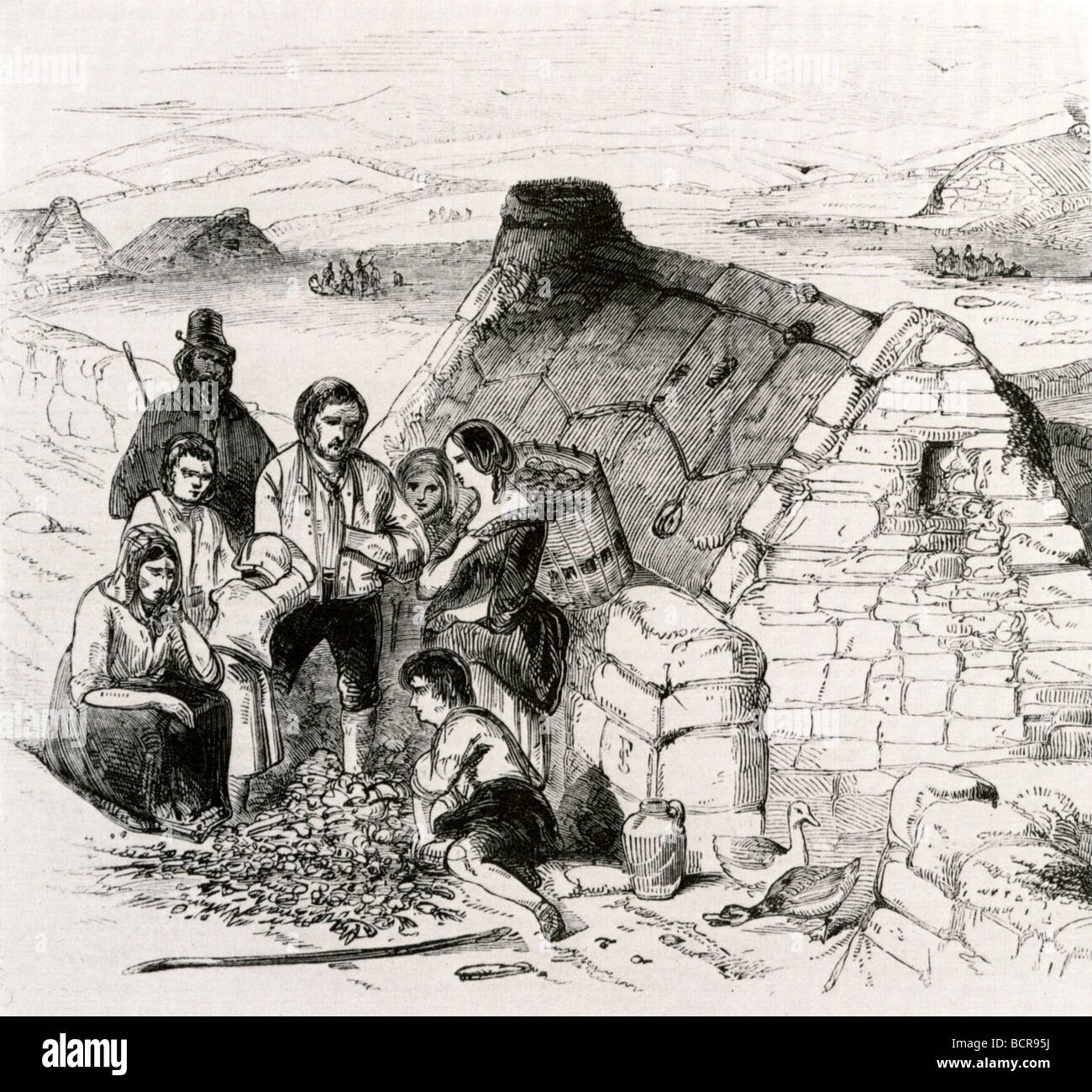 IRISH POTATO FAMINE 1845 - 1849 - a starving Irish family outside their turf-roofed cottage