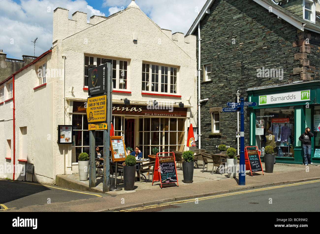 Diners People tourists visitors outside a bar pub in summer Keswick Cumbria England UK United Kingdom GB Great Britain Stock Photo