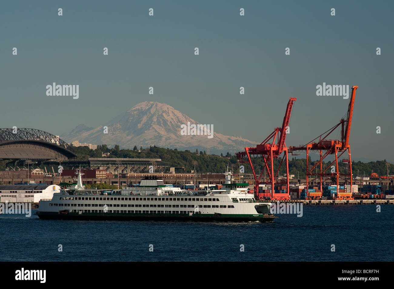 Mount Rainier with Port of Seattle cranes and ferry boat on Elliott Bay ...