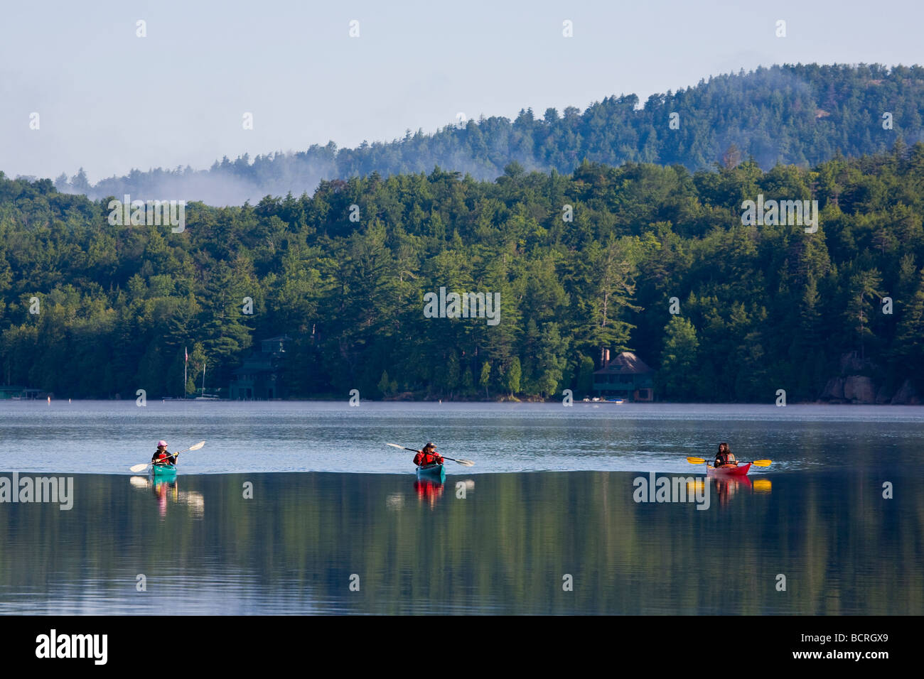 Kayakers on Fourth Lake near Inlet in the Adirondack Mountains of New York Stock Photo
