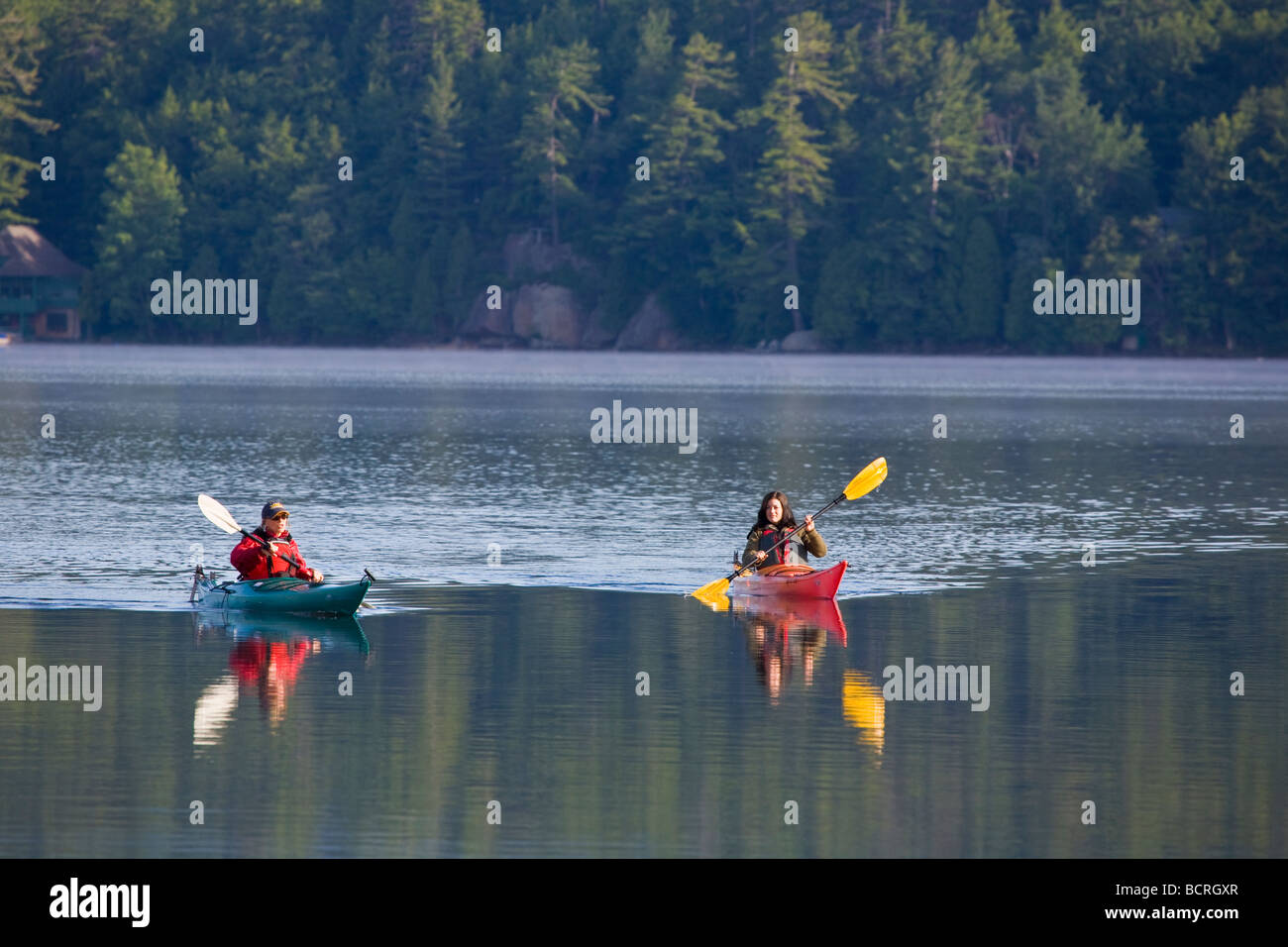 Kayakers on Fourth Lake near Inlet in the Adirondack Mountains of New York Stock Photo