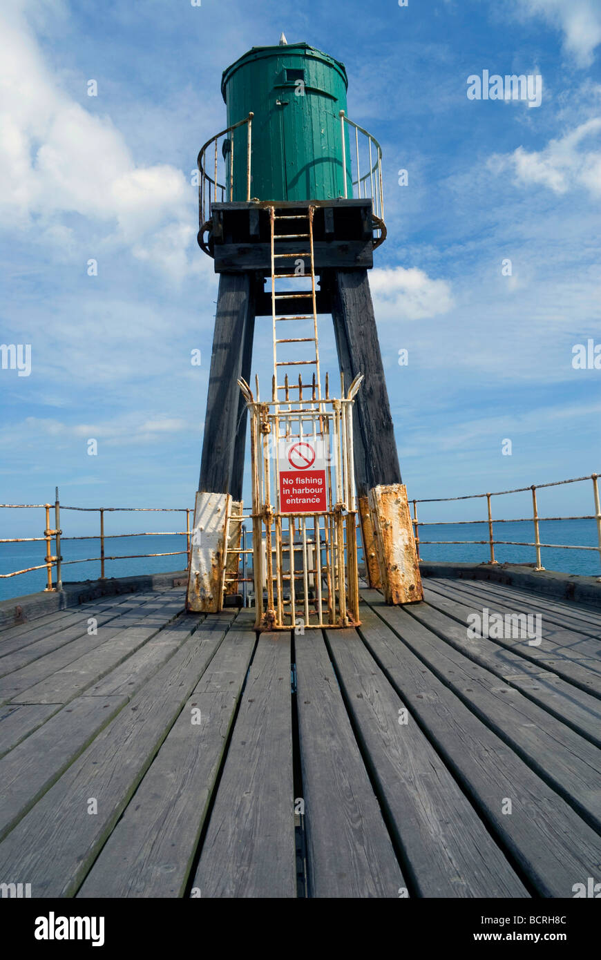 Green navigation beacon at the entrance to Whitby pier Stock Photo - Alamy