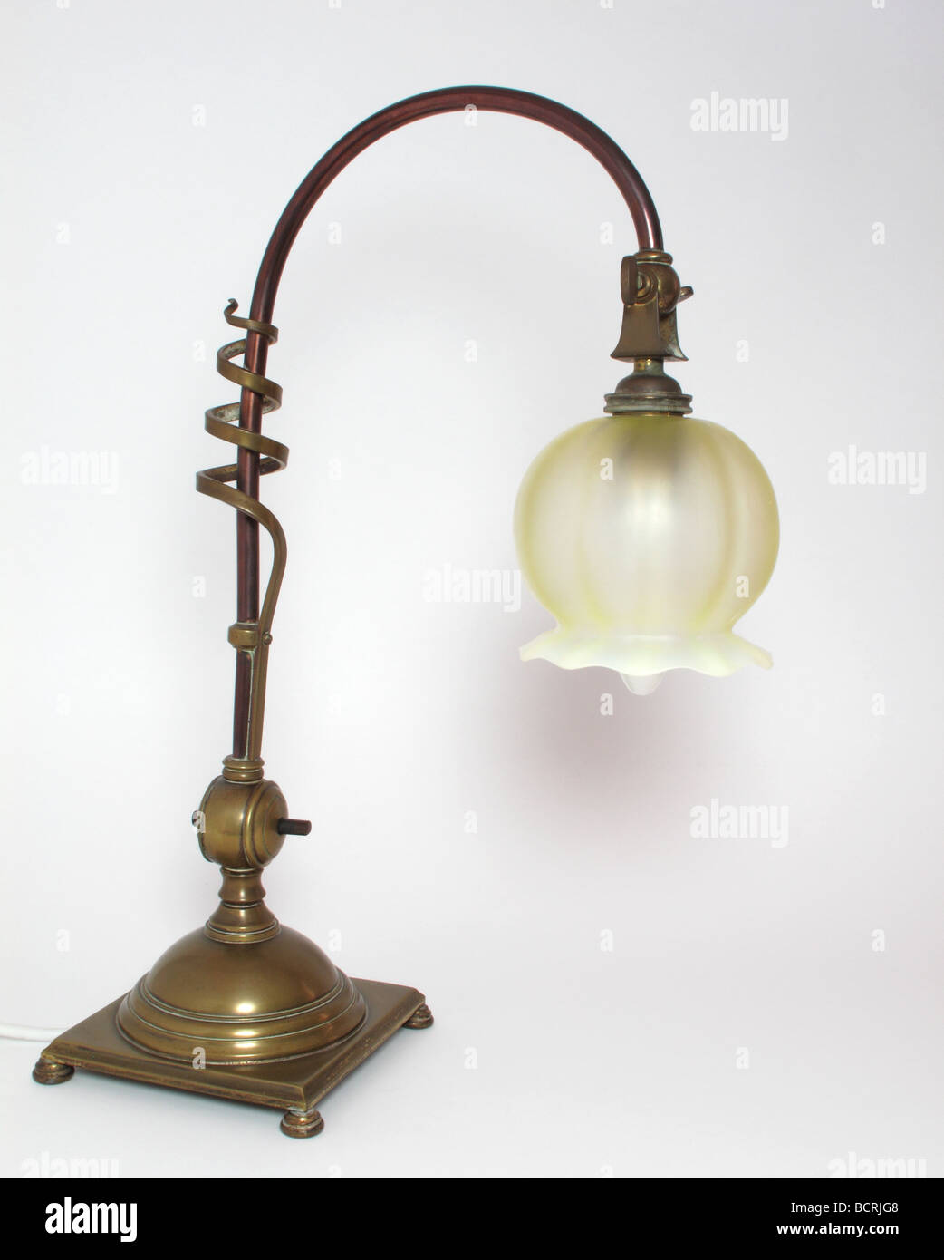 Arts and Crafts copper and brass table lamp with opalescent glass shade by the English maker W.A.S. Benson circa 1890 Stock Photo