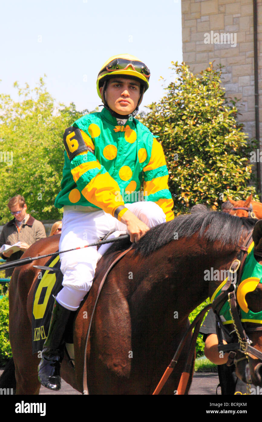 A jockey rides his thoroughbred from the paddock onto the track at Keeneland Race Course Lexington Kentucky Stock Photo