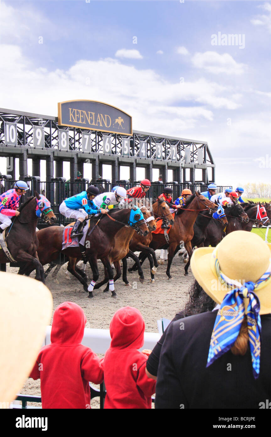 Spectators watch thoroughbreds leave starting gate Spring horse races Keeneland Race Course Lexington Kentucky Stock Photo