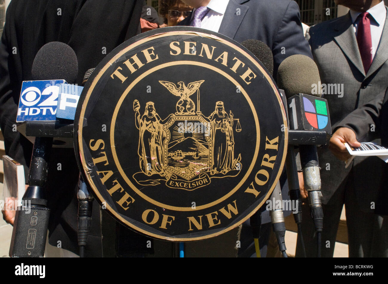 The seal of the New York State Senate on a microphone stand at a news conference at New York City Hall Stock Photo