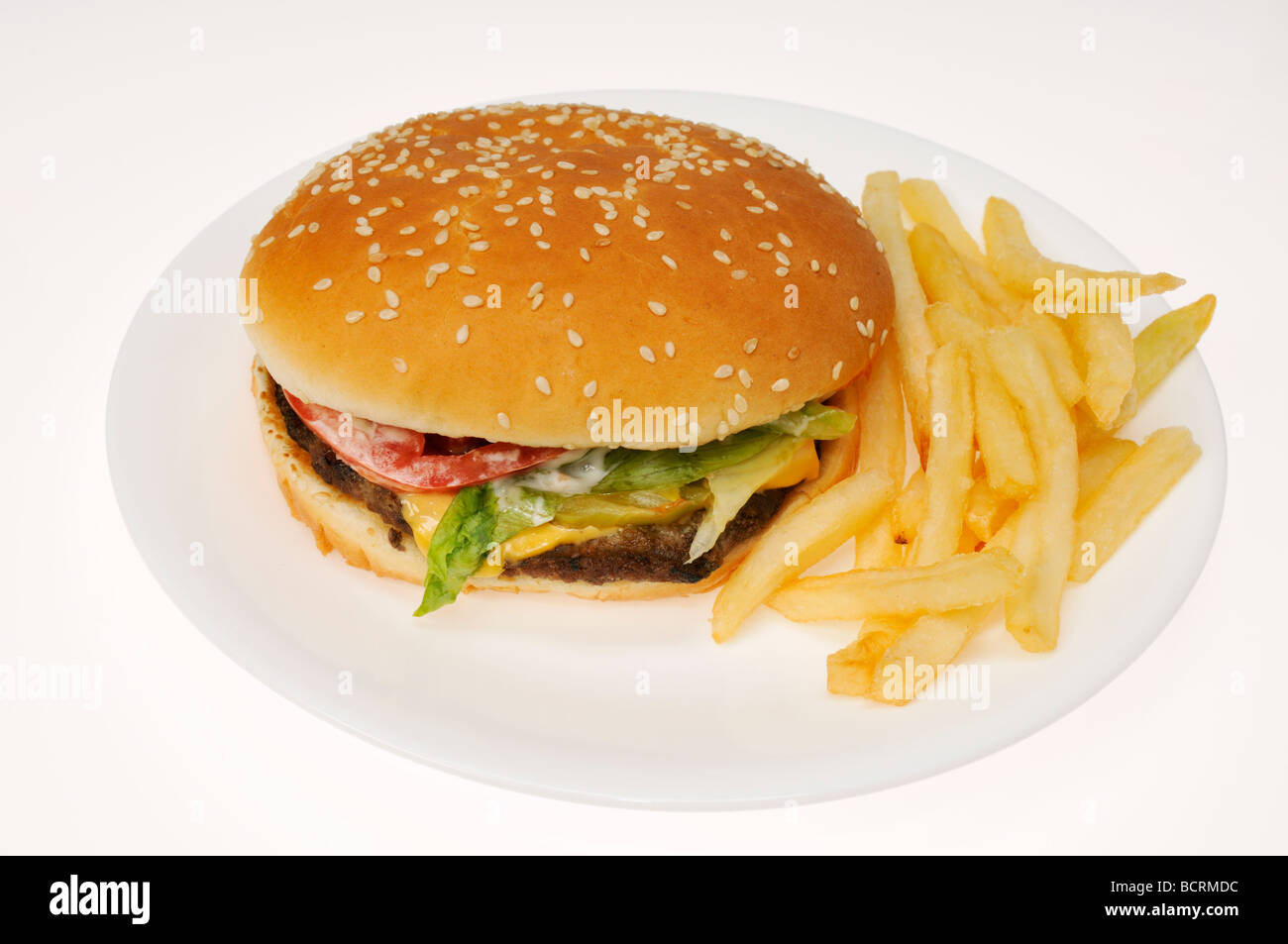 Whopper burger and chips or fries from Burger King on white plate on white background, cutout. Stock Photo
