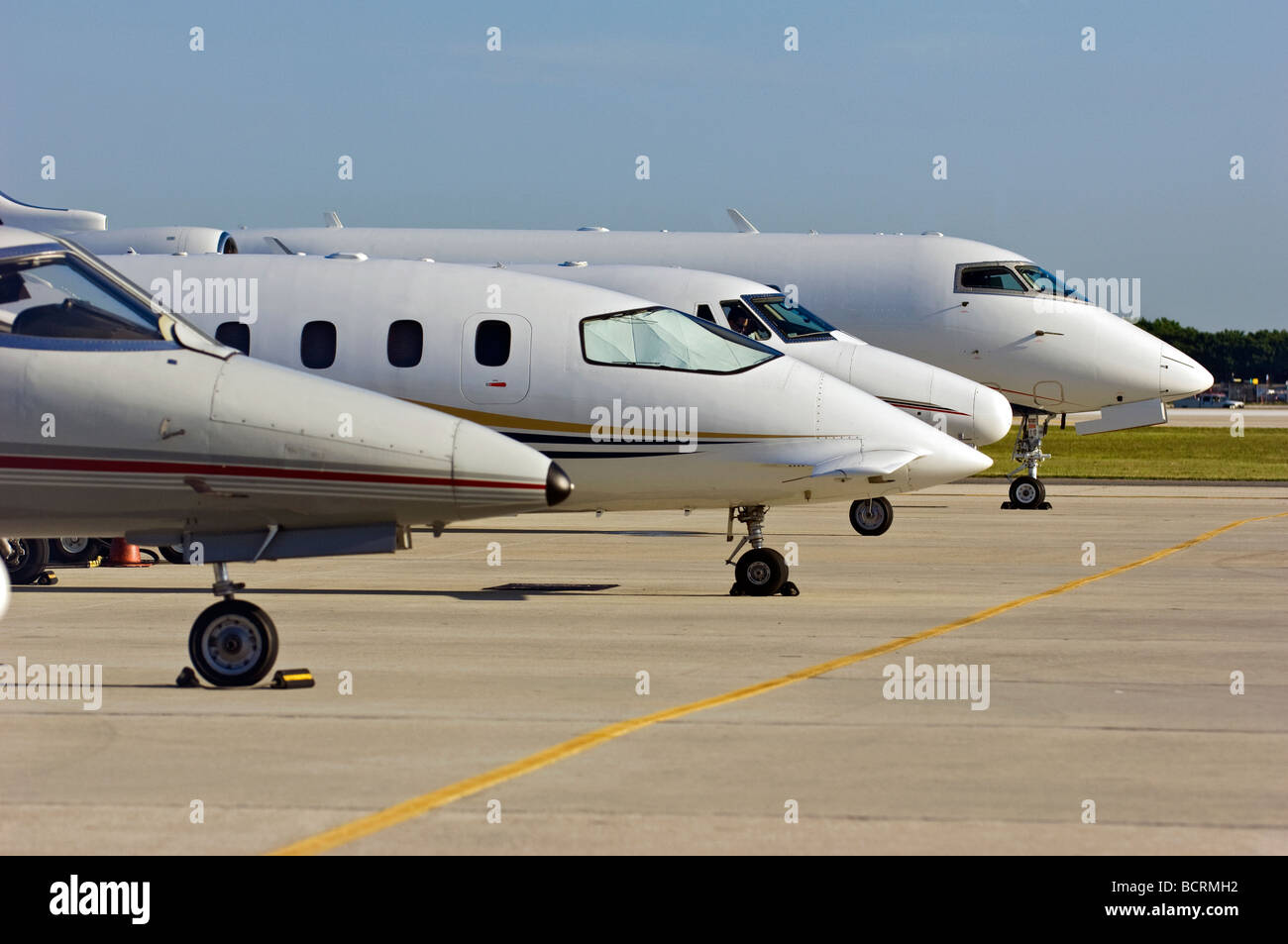 variety of jets on tarmac at airport Stock Photo - Alamy