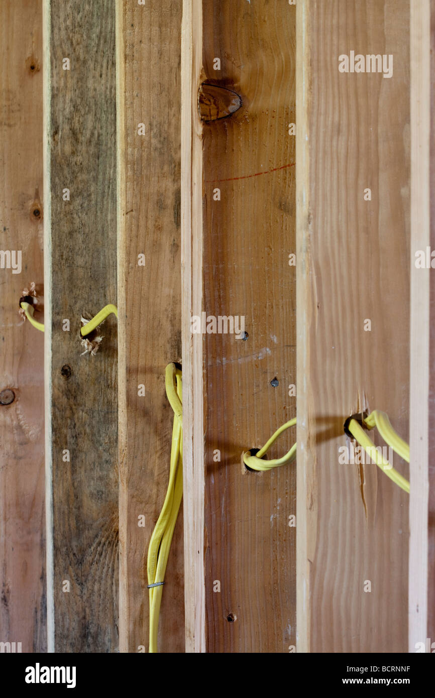 Electrical wires running through wood wall studs at residential  construction site Stock Photo - Alamy