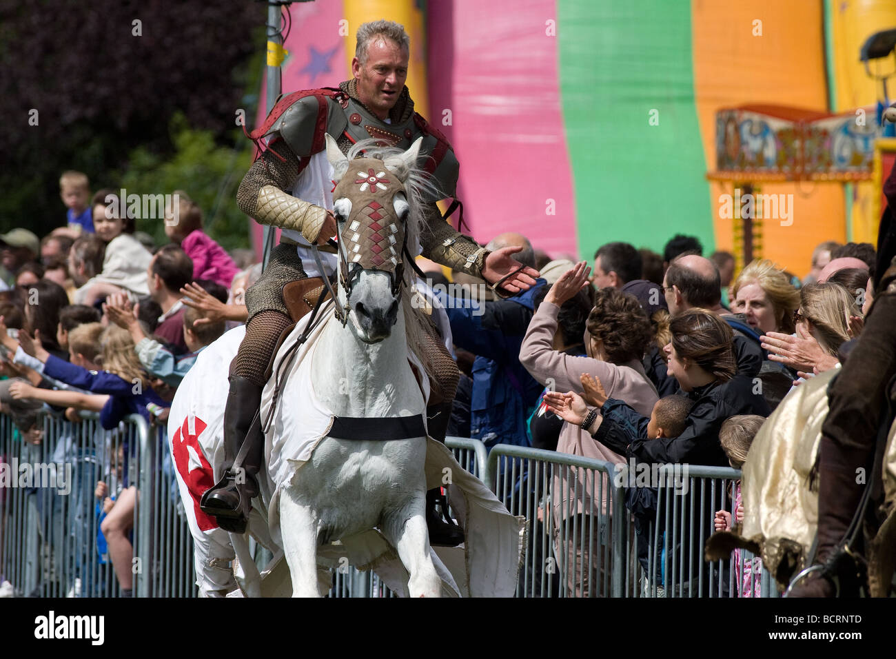 black knight white horse canter joust medieval Lambeth Country Show, Brockwell Park, Tulse Hill, London, England, UK, Europe Stock Photo