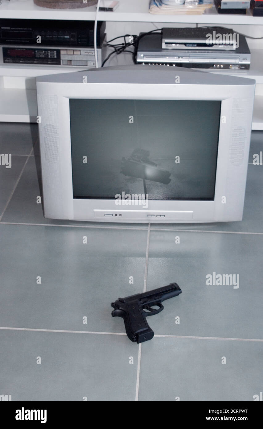 handgun and tv on floor Stock Photo
