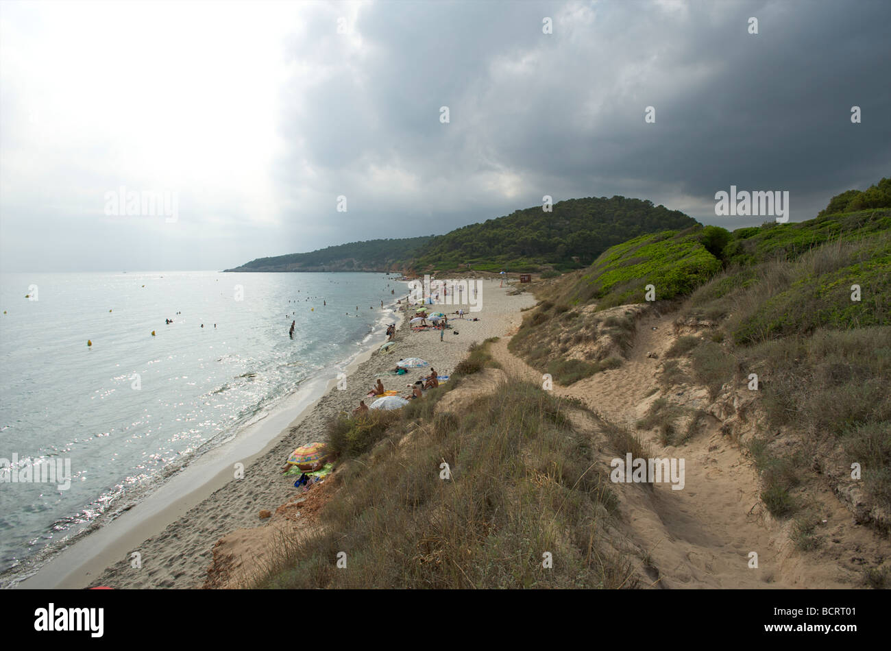Storm clouds gather behind the beach of Binigaus Menorca Stock Photo
