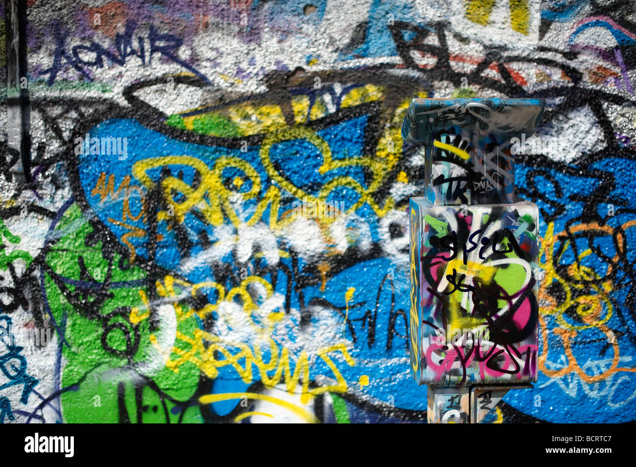 Parking meter covered in graffiti along with Wall, Windmill Lane Dublin Ireland Stock Photo