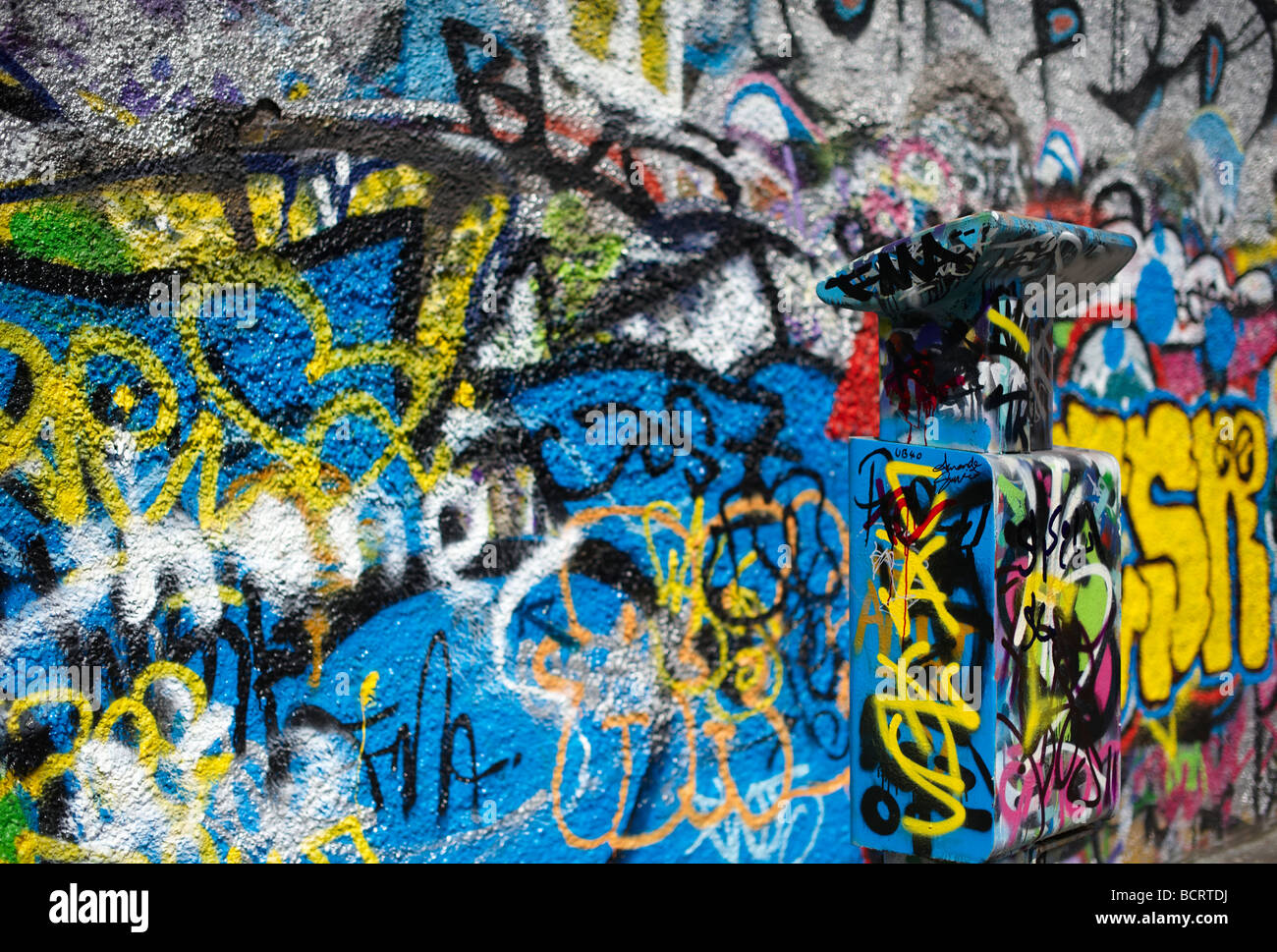 Parking meter covered in graffiti along with Wall, Windmill Lane Dublin Ireland Stock Photo