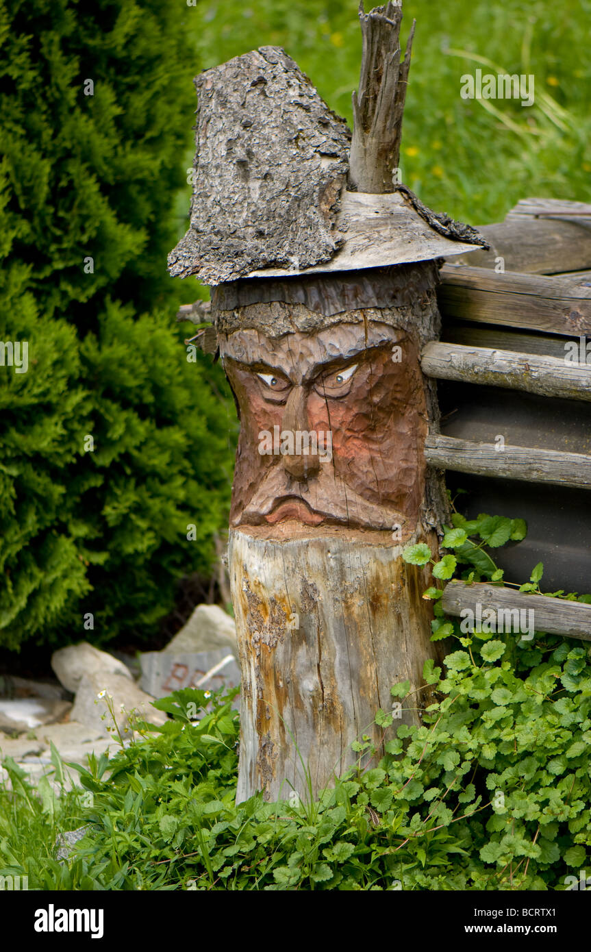 Wood carving of a old mans head formed out of a solid log. Stock Photo