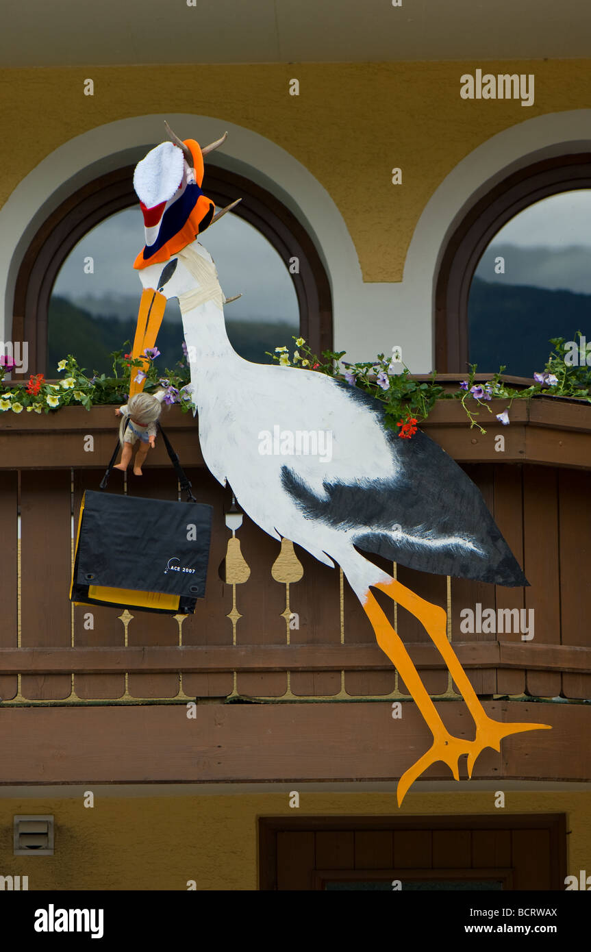 A traditional Austrian method of showing a new baby birth by placing a wooden carving of a Stork outside their home. Stock Photo