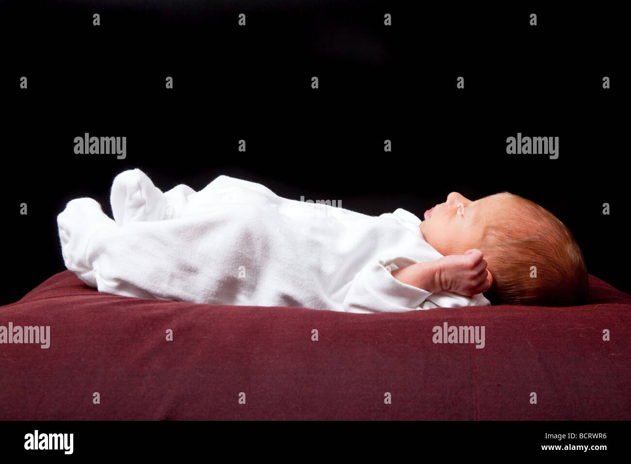 Sleeping Newborn Baby Boy Photographed On A Black Studio