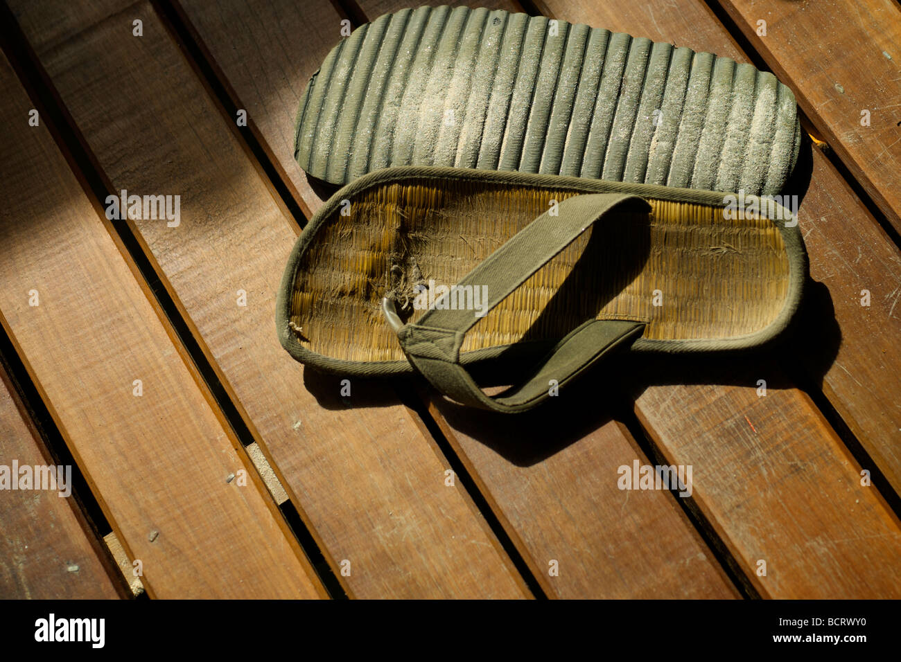 Flip flops (thongs) on a wooden deck of a beach bungalow in Thailand ...