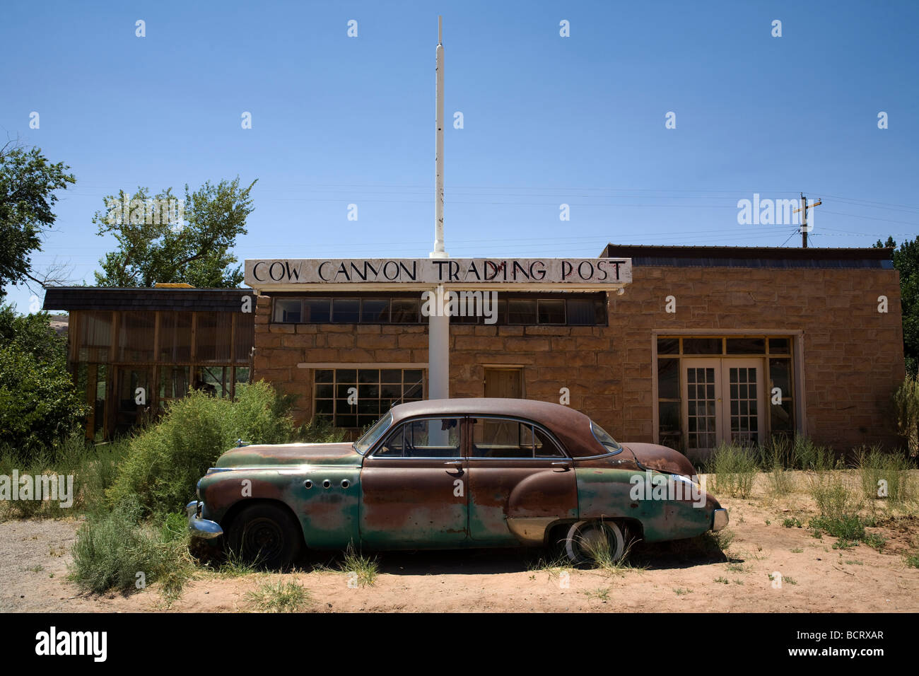 Old abandoned car in front of a closed restaurant near Mexican Water, Utah Stock Photo