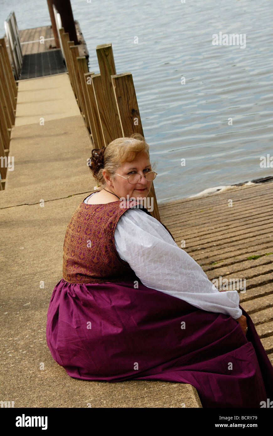 Woman by lake in period dress Stock Photo