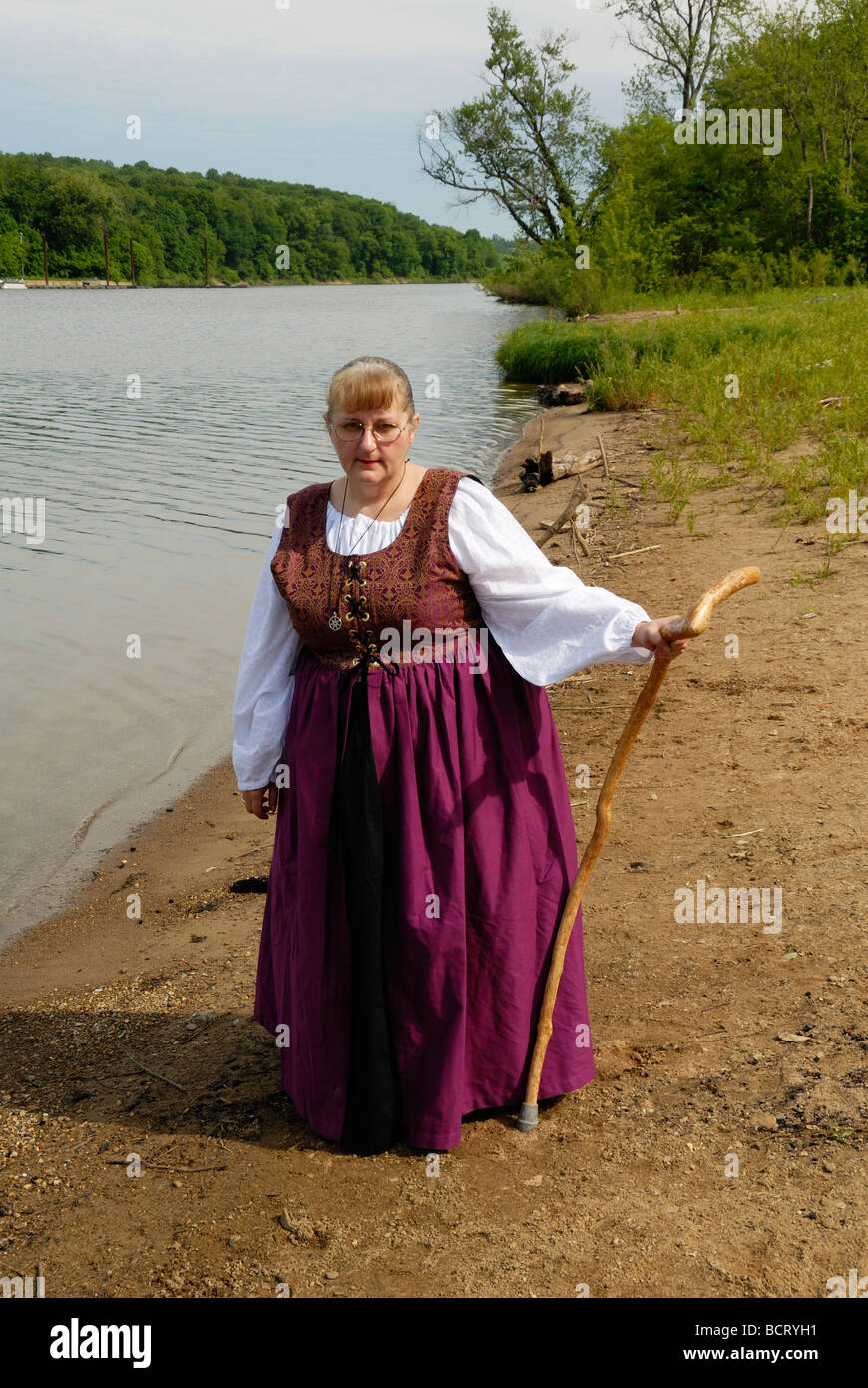 Woman by lake in period dress Stock Photo