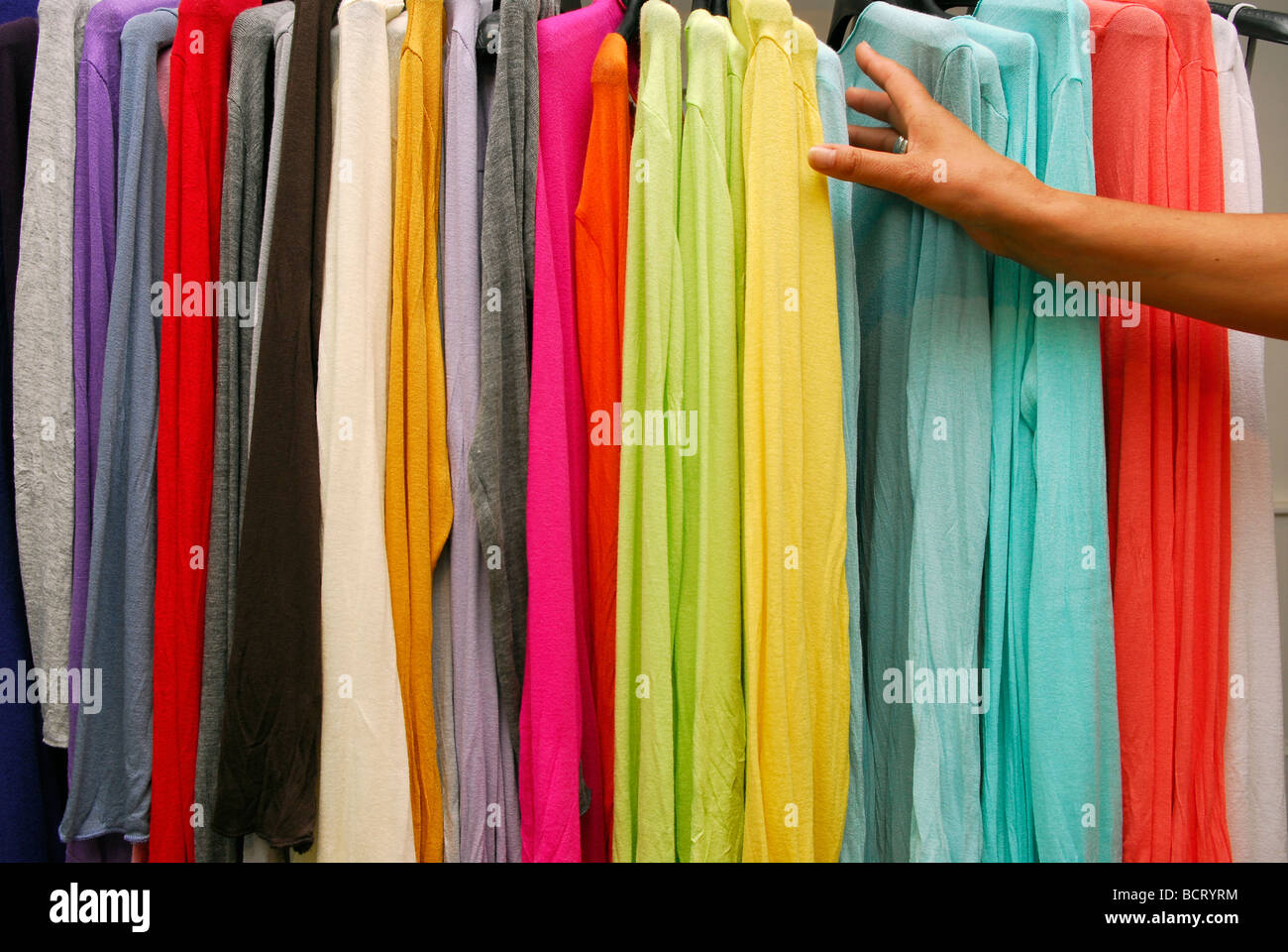 Woman looking for garment in women's clothes store, Haslemere, Surrey UK. Stock Photo