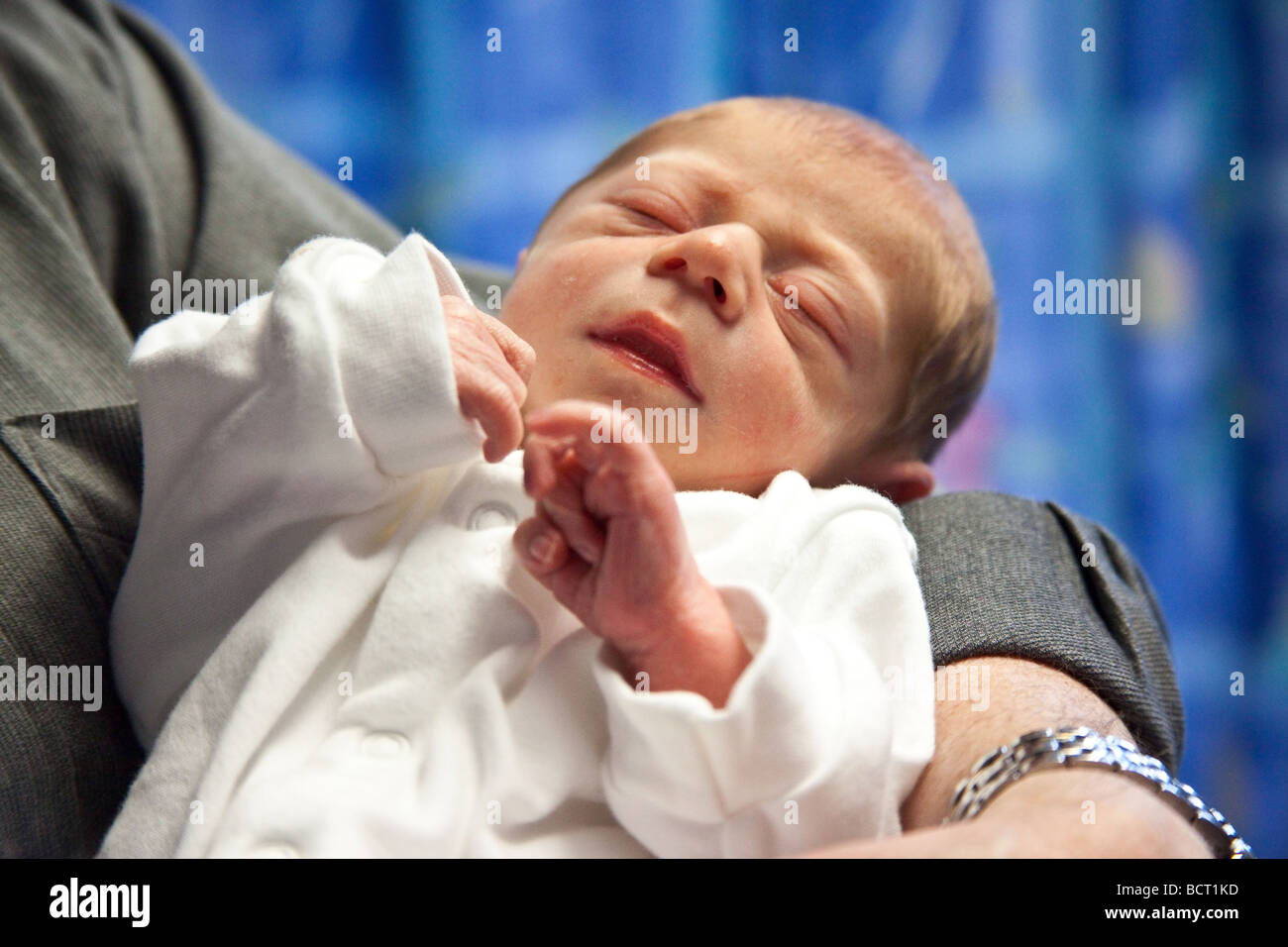A newborn baby boy (7 days old) being cuddled, London, England. Stock Photo
