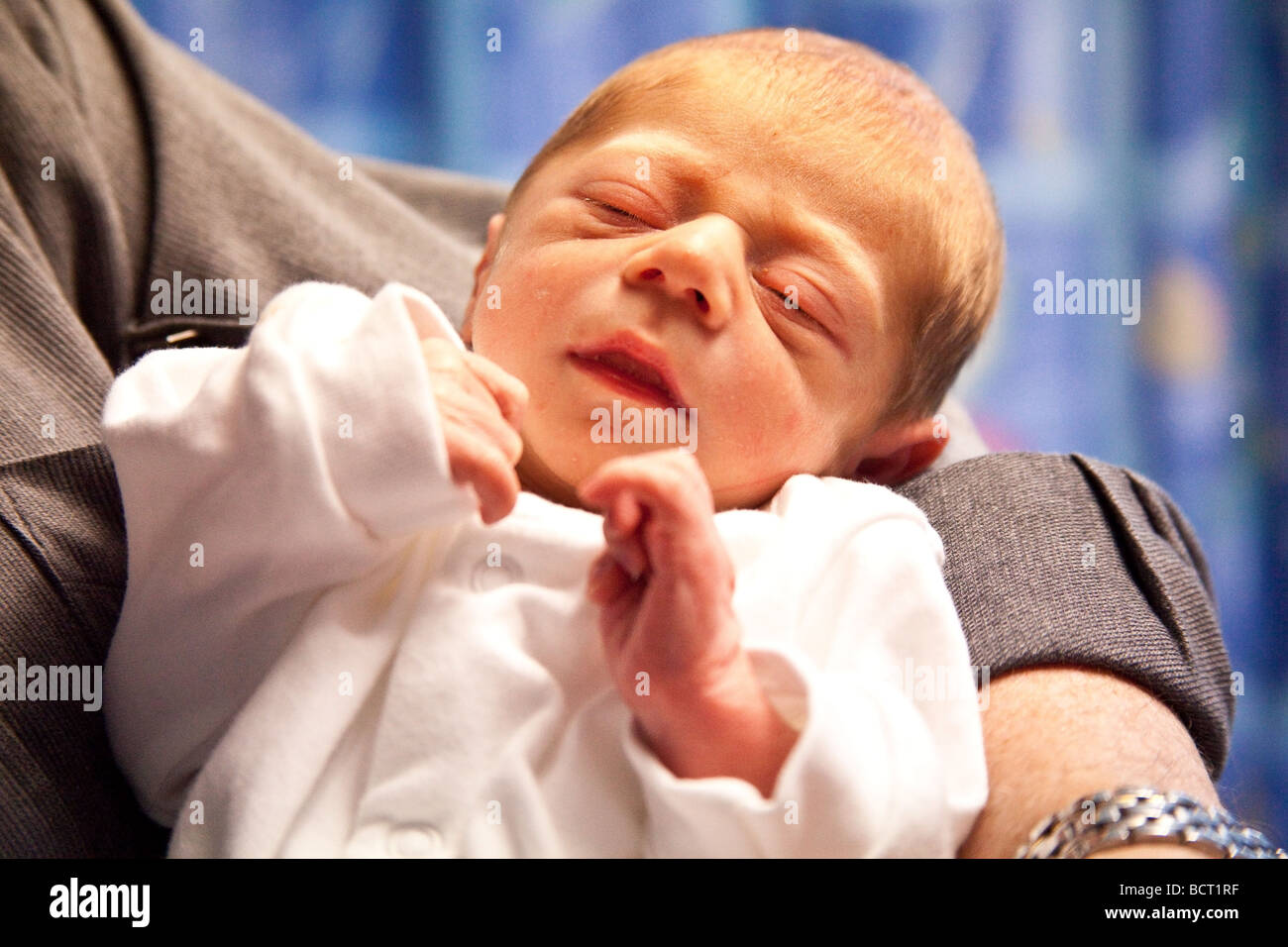 A newborn baby boy (7 days old) being cuddled, London, England. Stock Photo