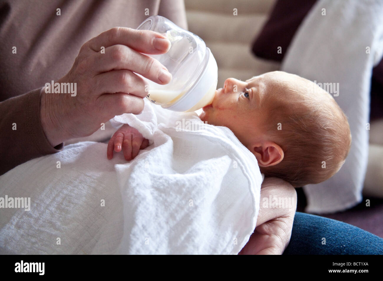 A newborn baby boy (7 days old) being bottle fed, London, England. Stock Photo