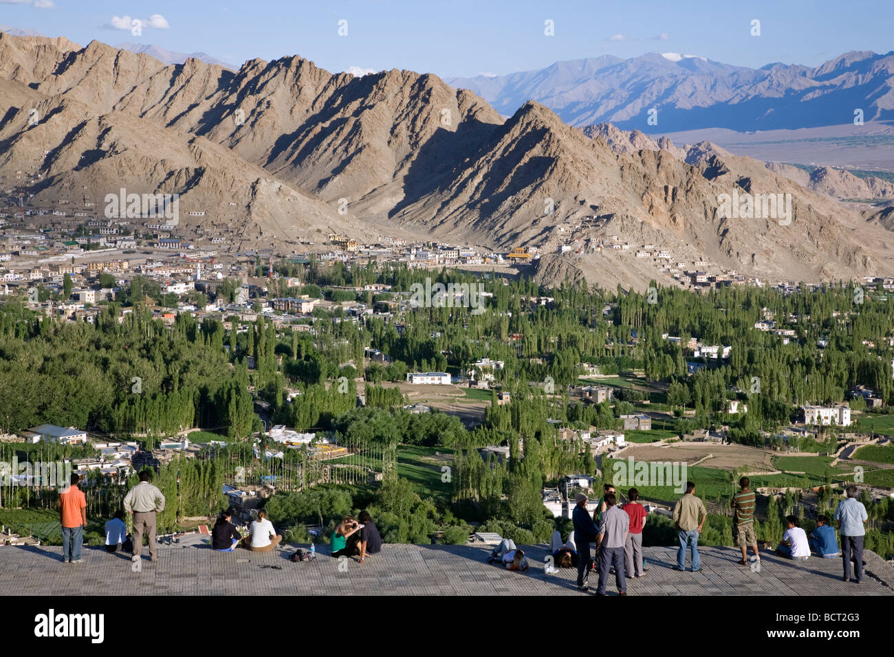 People contemplating Leh city from Shanti Stupa viewpoint. Leh. Ladakh. India Stock Photo