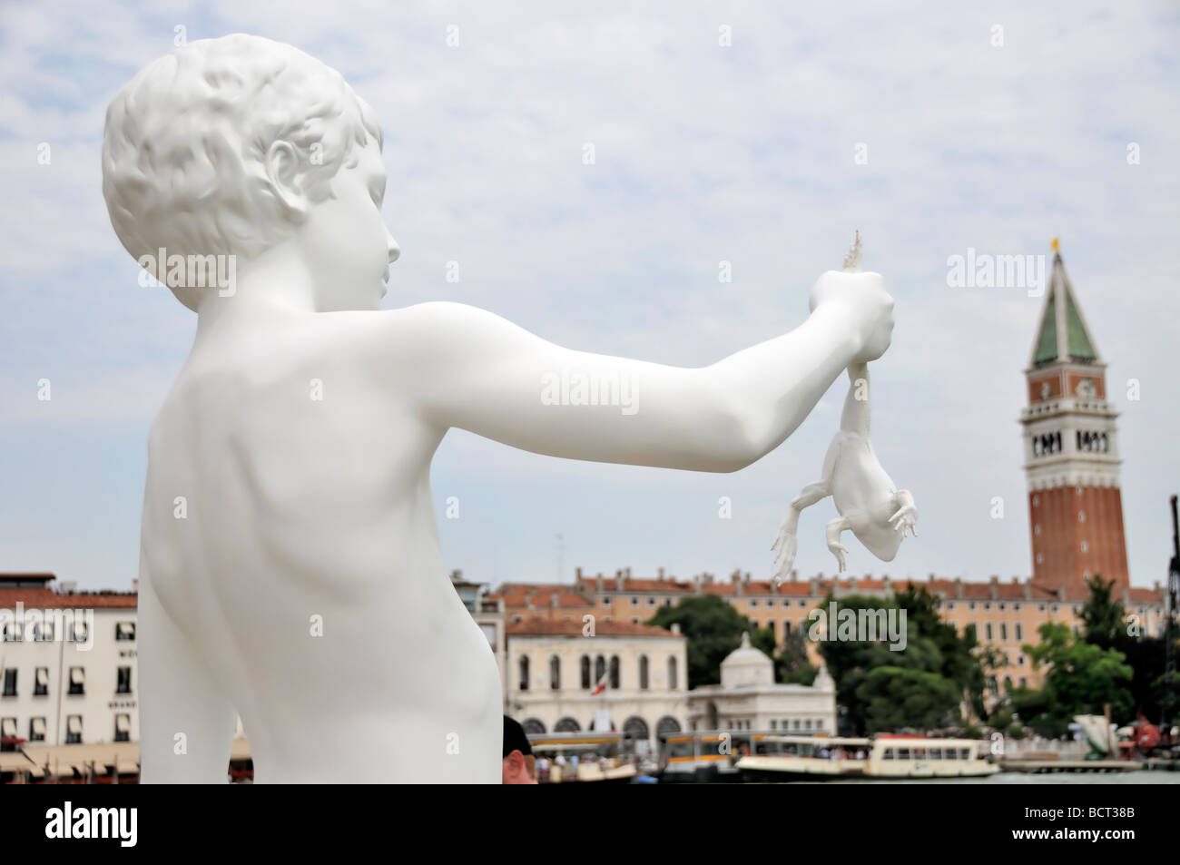 Venice, Veneto, Italy: statue of a boy holding a frog at art exhibit of biennale Stock Photo