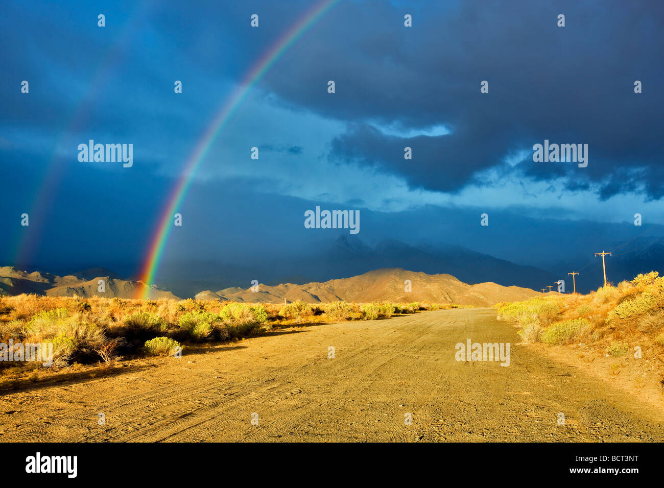 Rainbow over Eastern Sierra Mountains near Bishop California Stock Photo